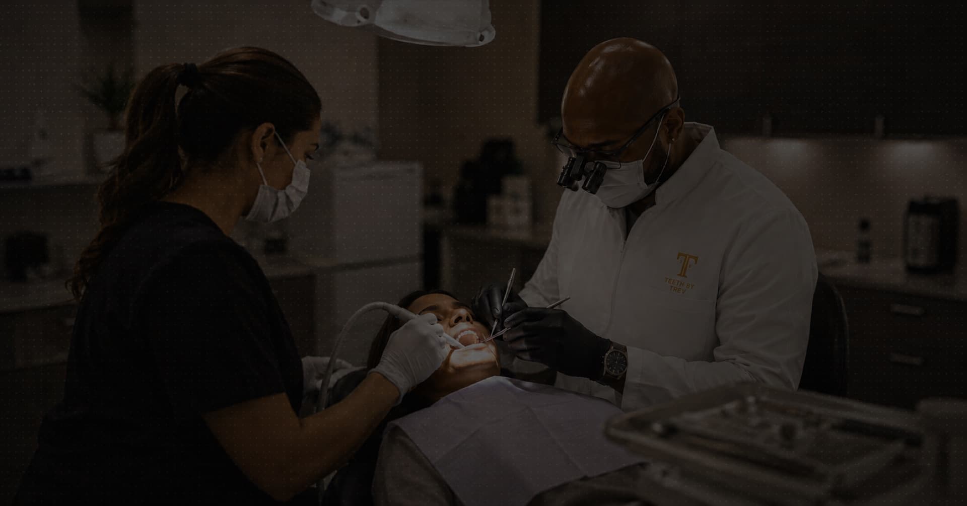 Dr. Trevor J. Thomas and his assistant caring for a patient in the studio